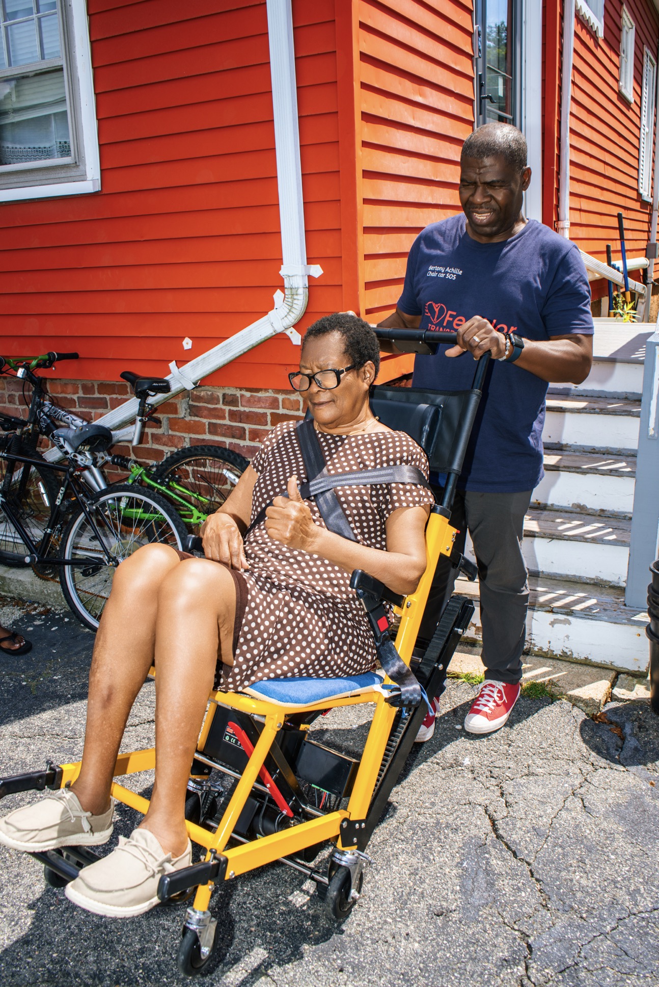 Seated passenger giving a thumbs up in a FedNor stair chair