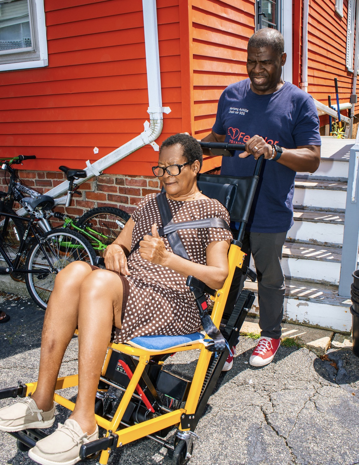 FedNor driver with a passenger comfortably seated in a stair chair