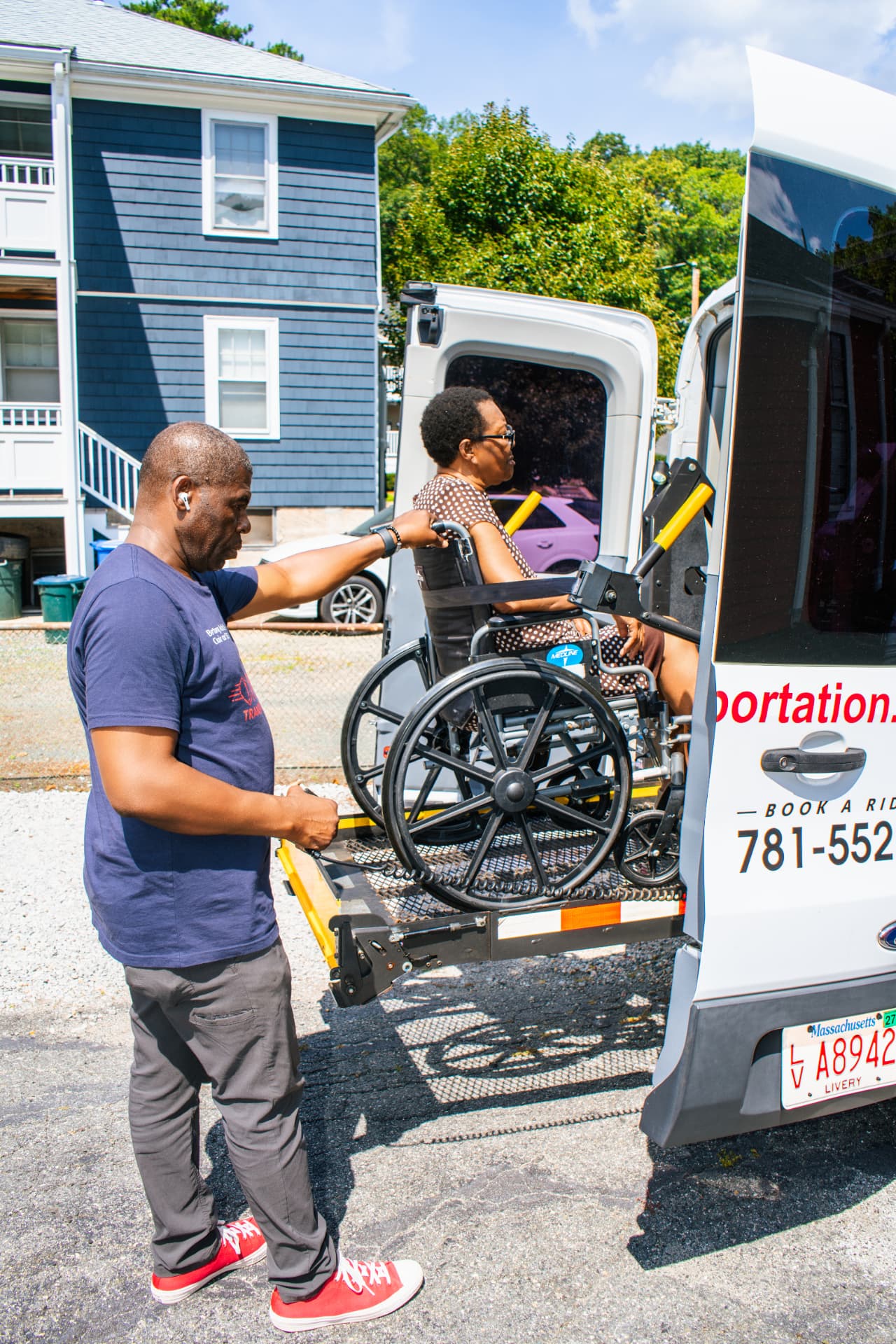 FedNor driver guiding a wheelchair rider onto the van ramp