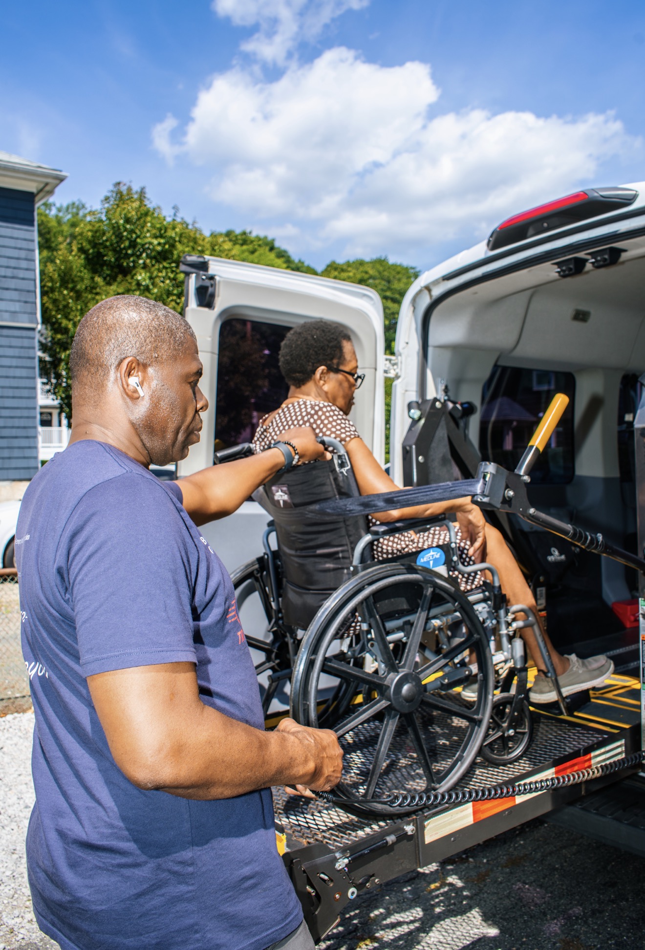 FedNor driver securing a wheelchair on the van's hydraulic lift