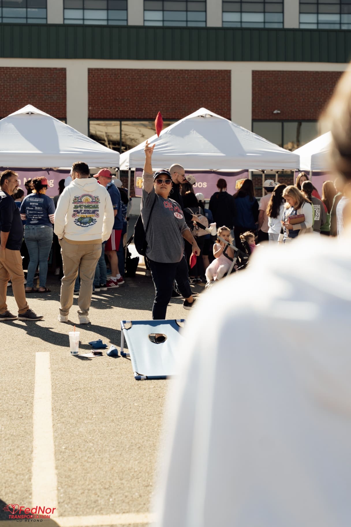 Cornhole bean bag toss in action at the Friendship Walk festival