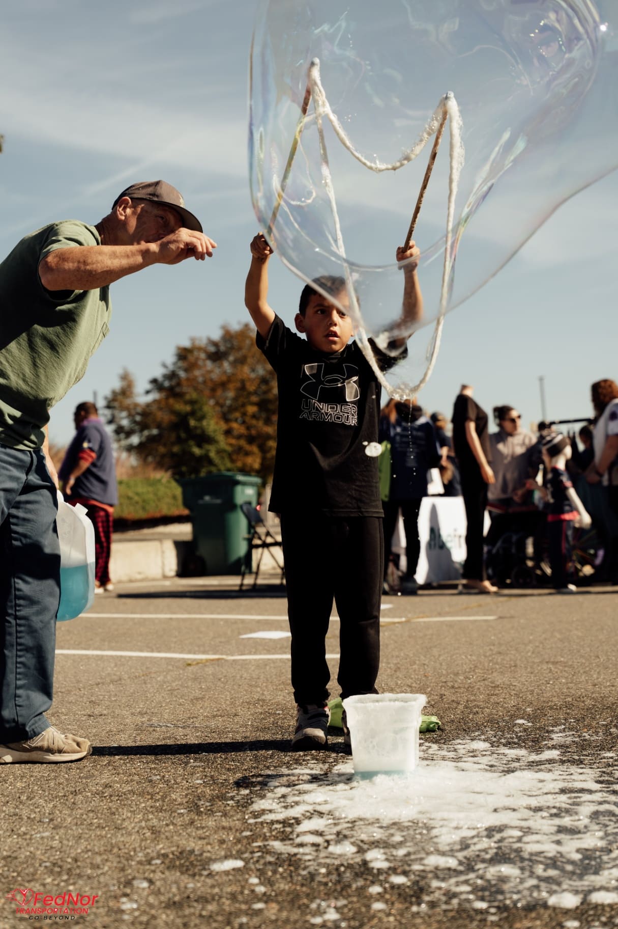 Father and son creating giant bubbles at the Friendship Walk