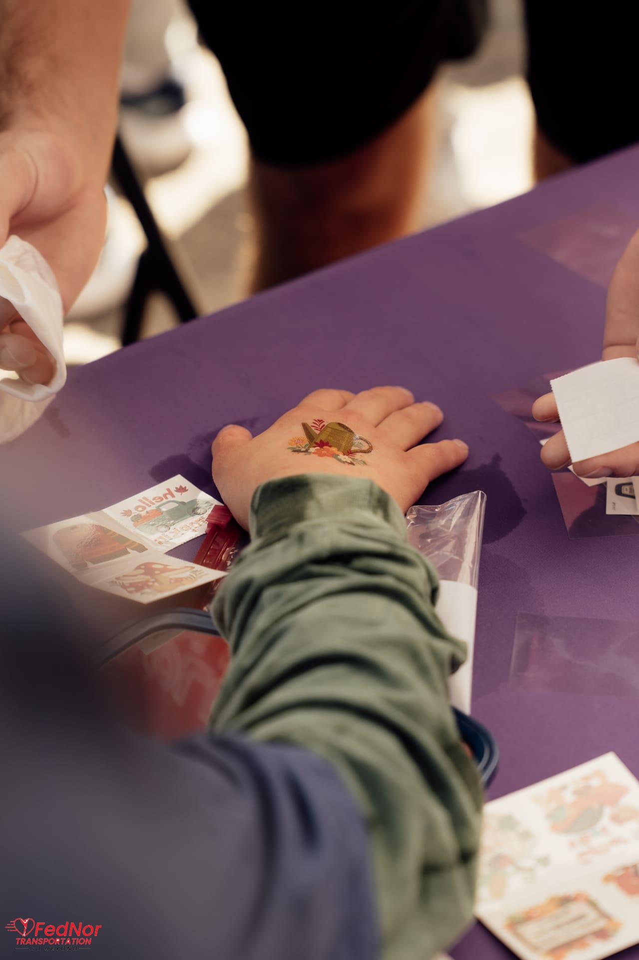 Temporary tattoo being applied at the Best Buddies activity table